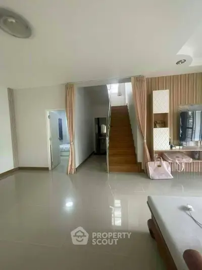 Spacious modern living room with staircase and elegant decor
