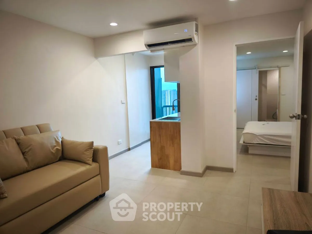 Modern apartment with open layout, featuring a cozy living room and bedroom, ideal for urban living.