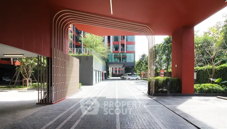Modern building entrance with sleek design and spacious driveway