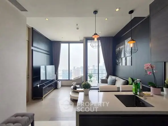 Modern living room with open kitchen and city view, stylish decor and natural light.