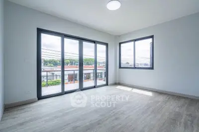 Spacious corner unit with large windows and modern flooring