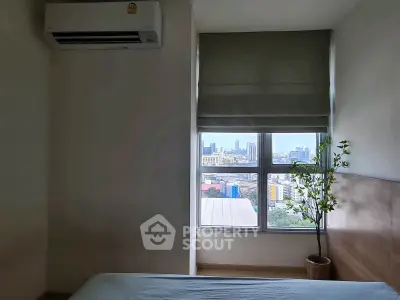Modern bedroom with city view, featuring air conditioning and minimalist decor, perfect for urban living.