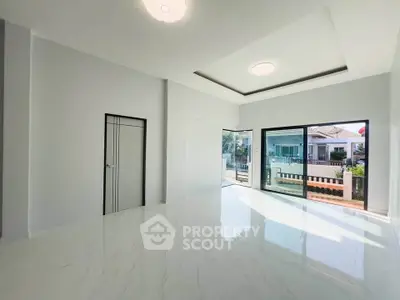 Spacious modern living room with large windows and elegant flooring