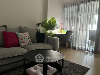 Cozy living room with modern decor and natural light from large window