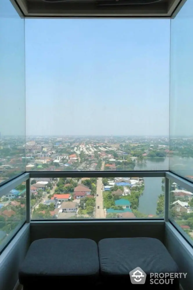 Stunning panoramic view from a high-rise balcony overlooking the cityscape and river.