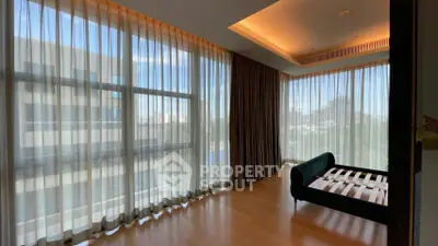 Spacious corner unit with floor-to-ceiling windows and elegant hardwood flooring.