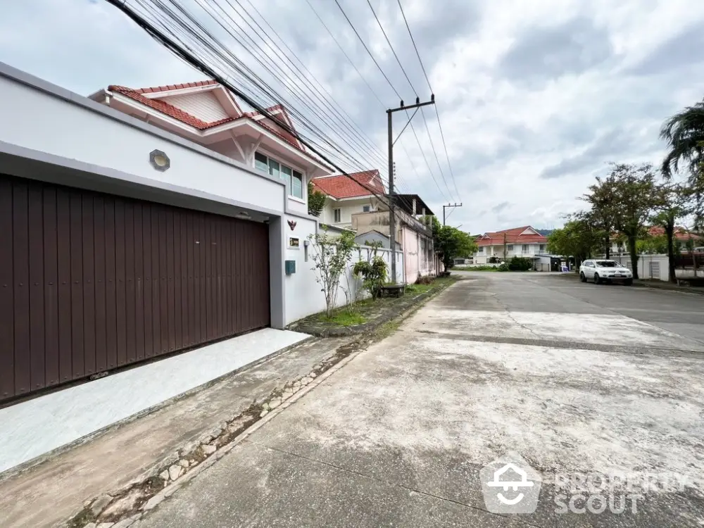 Charming suburban street view with modern houses and spacious driveways, perfect for family living.