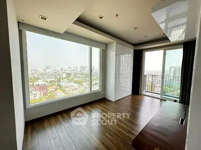 Spacious modern living room with large windows and city view