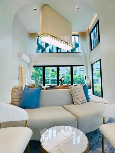 Luxurious modern living room with high ceilings and large windows