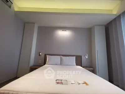 Modern bedroom with stylish lighting and cozy bed in a contemporary apartment.