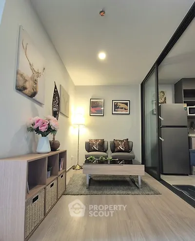 Modern living room with stylish decor and open kitchen layout in a cozy apartment.