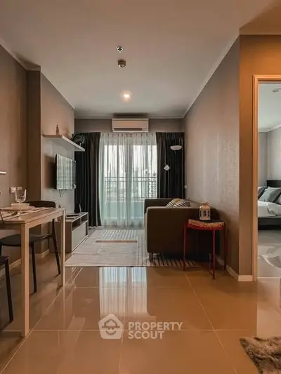 Modern living room with sleek design and natural light, featuring a cozy seating area and stylish decor.