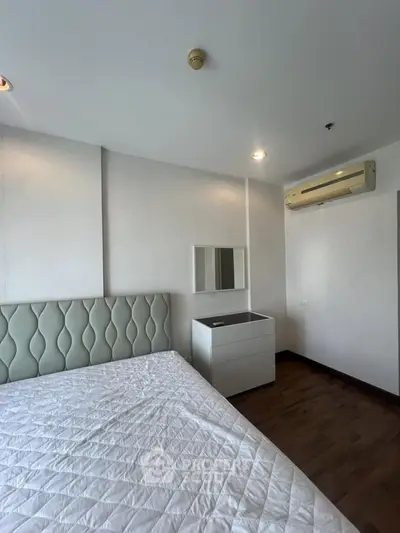 Modern bedroom with stylish headboard and air conditioning in a contemporary apartment.