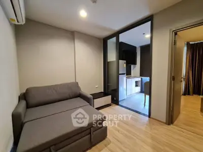 Modern living room with sleek design and open kitchen layout