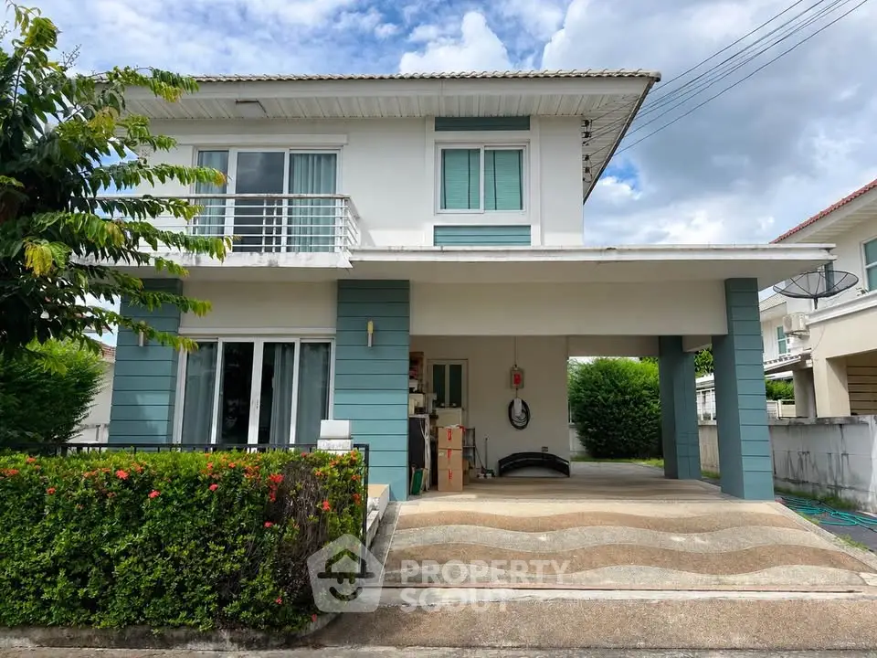 Charming two-story house with modern design and lush greenery in a serene neighborhood.