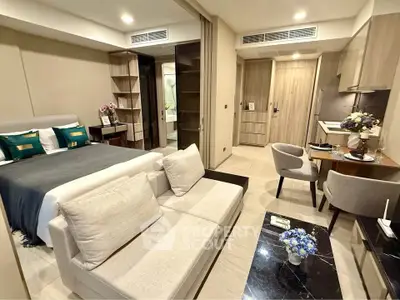 Luxurious studio apartment with modern decor, featuring a cozy living area and elegant bedroom setup.