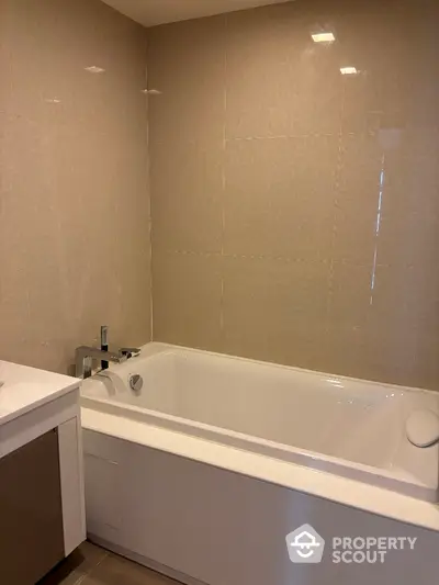 Modern bathroom with sleek bathtub and elegant tile design