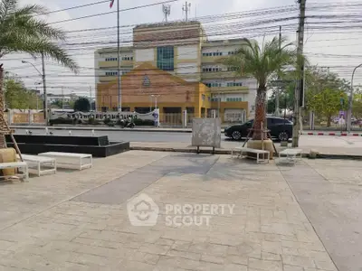 Spacious urban exterior with palm trees and modern building view