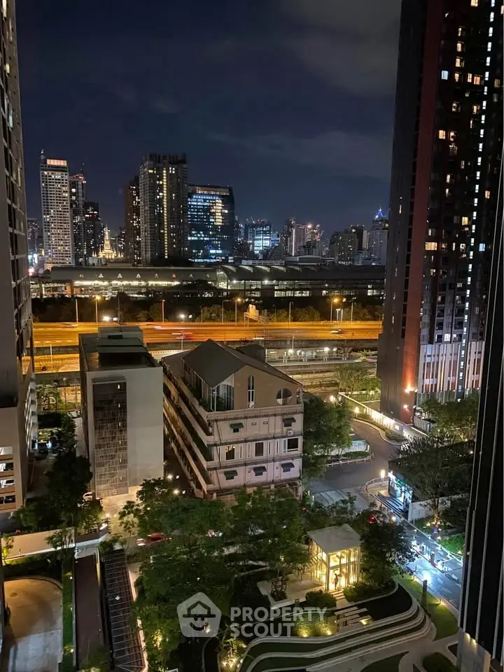 Stunning cityscape view from high-rise building at night, showcasing urban skyline and vibrant lights.
