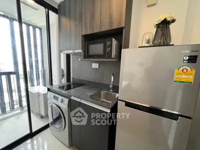 Modern compact kitchen with washing machine and balcony view