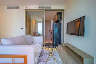 Modern living room with sleek furniture and open kitchen layout in a stylish apartment.