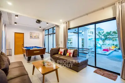 Luxurious living room with pool view and billiard table in modern villa