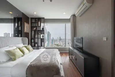 Luxurious bedroom with city view, modern decor, and large window for natural light.