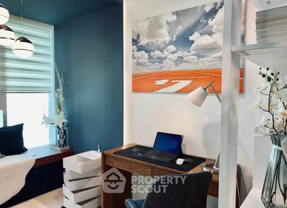 Modern study room with stylish decor and natural light, featuring a sleek desk and comfortable seating.