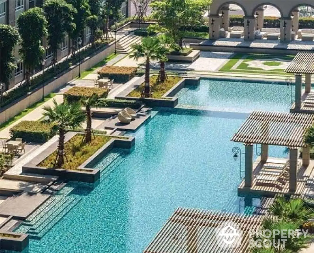 Luxurious outdoor pool area with elegant landscaping and seating, perfect for relaxation and leisure.