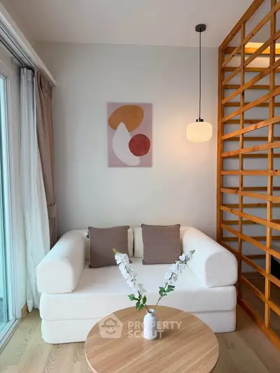 Chic modern living room with cozy white sofa, wooden accents, and stylish wall art, perfect for relaxation.