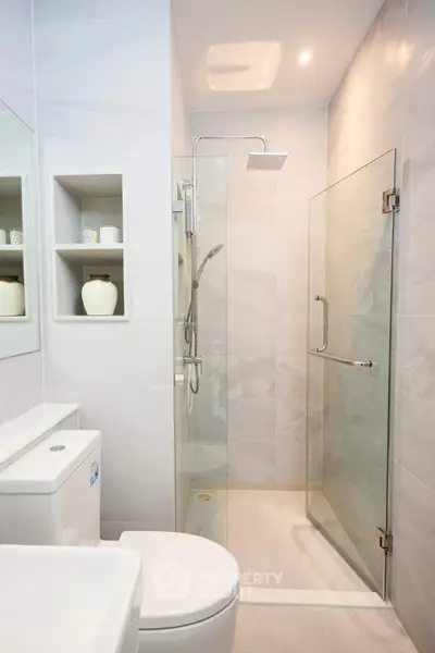 Modern bathroom with glass shower and sleek fixtures