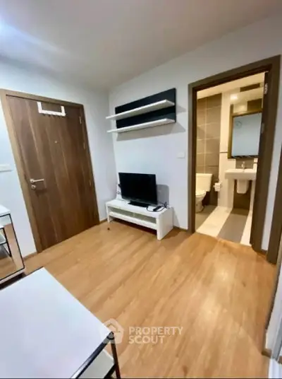 Modern apartment interior with wooden flooring and compact living area.