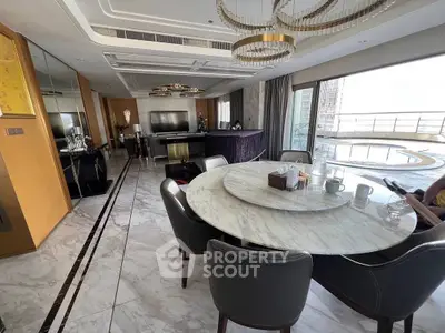 Luxurious open-plan living and dining area with marble floors and stunning city view balcony.