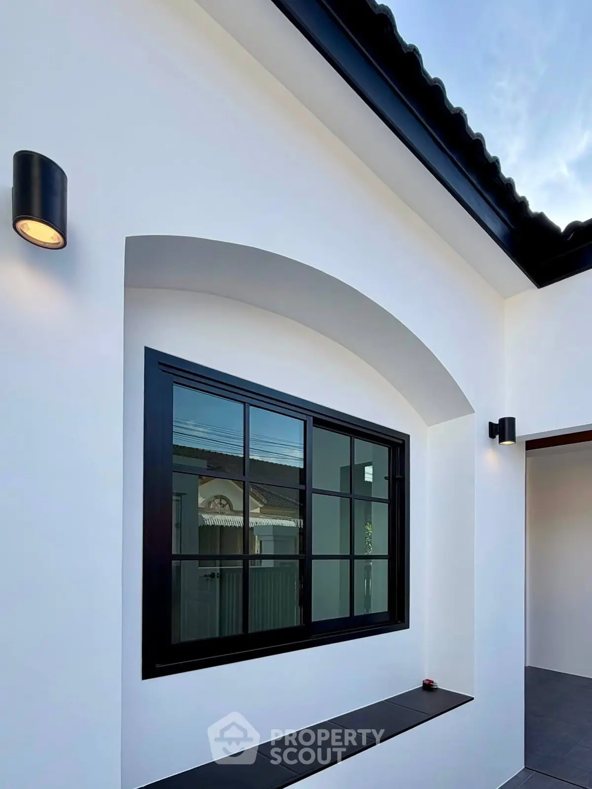 Modern exterior with sleek black window frames and elegant lighting