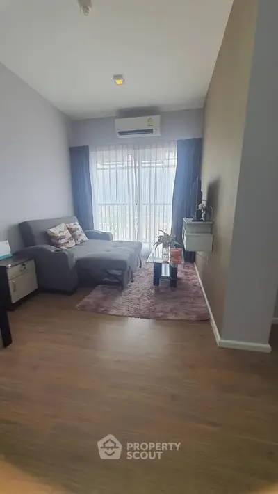 Cozy living room with modern decor and natural light, featuring a comfortable sofa and stylish coffee table.