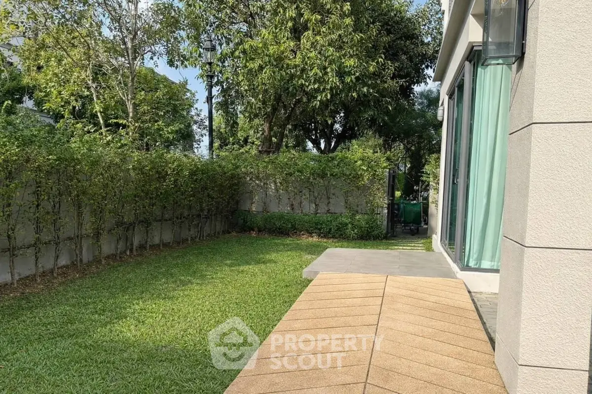 Charming garden view with lush greenery and modern patio in a serene residential setting.