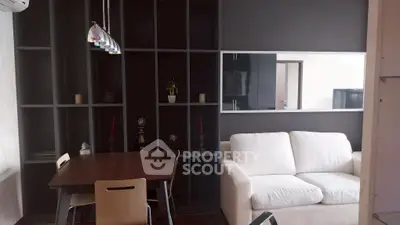 Modern living room with sleek shelving and cozy white sofa