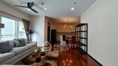 Spacious modern living room with elegant decor and open layout, featuring hardwood floors and stylish lighting.
