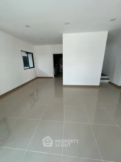 Spacious empty room with glossy tiled flooring and modern design
