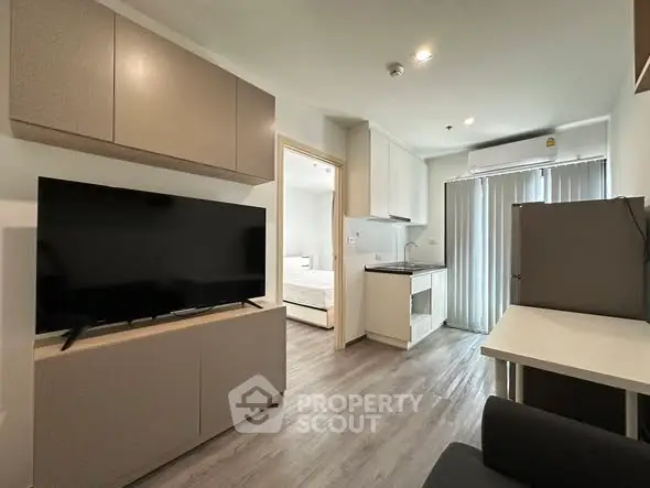 Modern studio apartment with sleek kitchen and cozy living area, perfect for urban living.