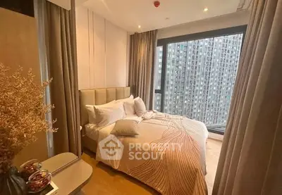Modern bedroom with large window offering stunning city view in high-rise apartment.