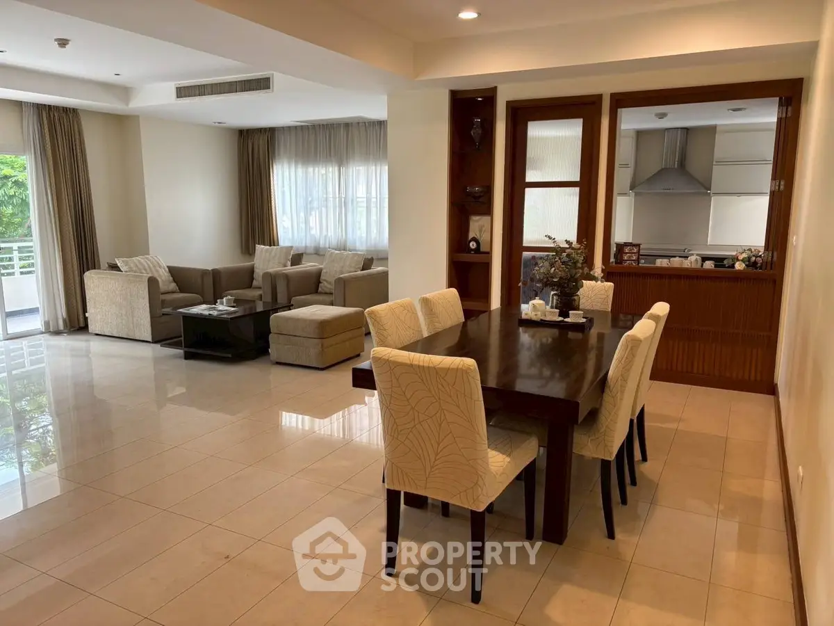 Spacious open-plan living and dining area with elegant furnishings and natural light.