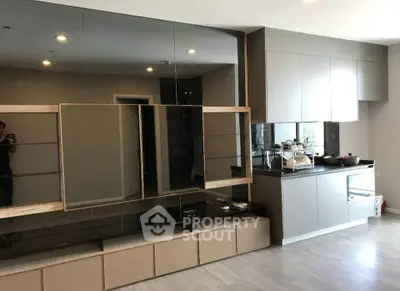 Modern kitchen with sleek cabinetry and integrated appliances in a stylish apartment.