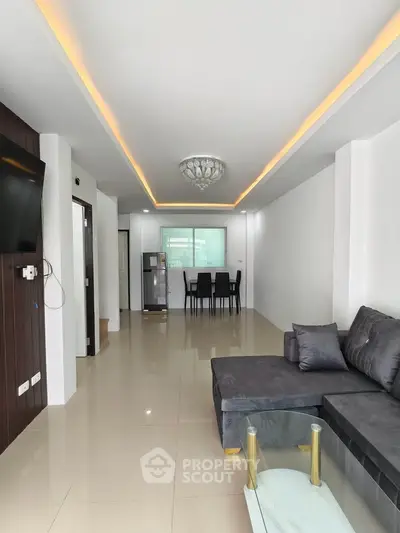 Spacious modern living room with sleek design and elegant lighting