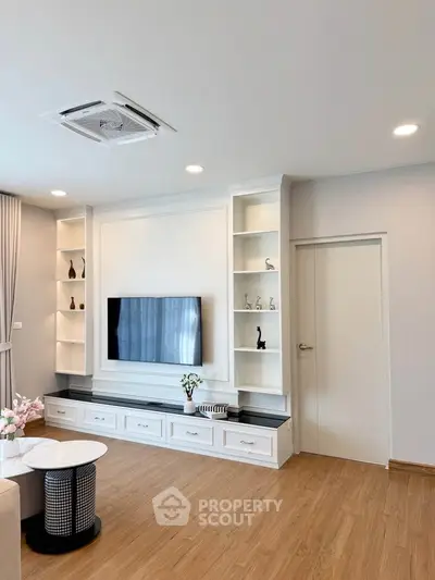 Modern living room with built-in TV unit and elegant decor