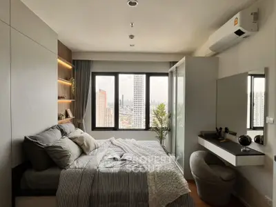 Modern bedroom with city view, featuring cozy bed, stylish decor, and ample natural light.