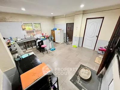 Spacious kitchen with tiled flooring and modern appliances, featuring a closed layout and ample natural light.