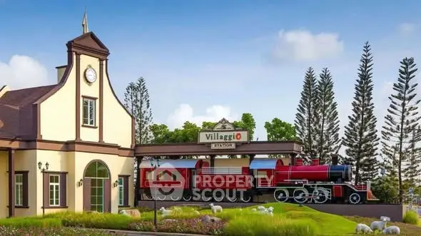 Charming village station with vintage train and lush greenery, perfect for picturesque real estate development.
