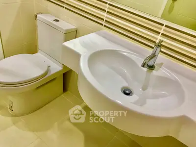 Modern bathroom with sleek white fixtures and elegant tile design