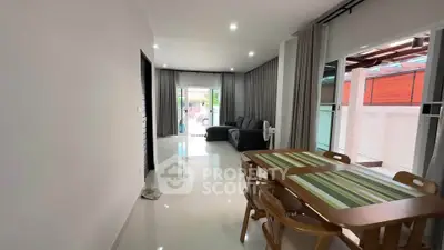 Spacious living room with modern dining area and large windows for natural light.